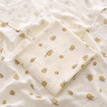 White fabric with yellow lemon pattern, folded neatly.