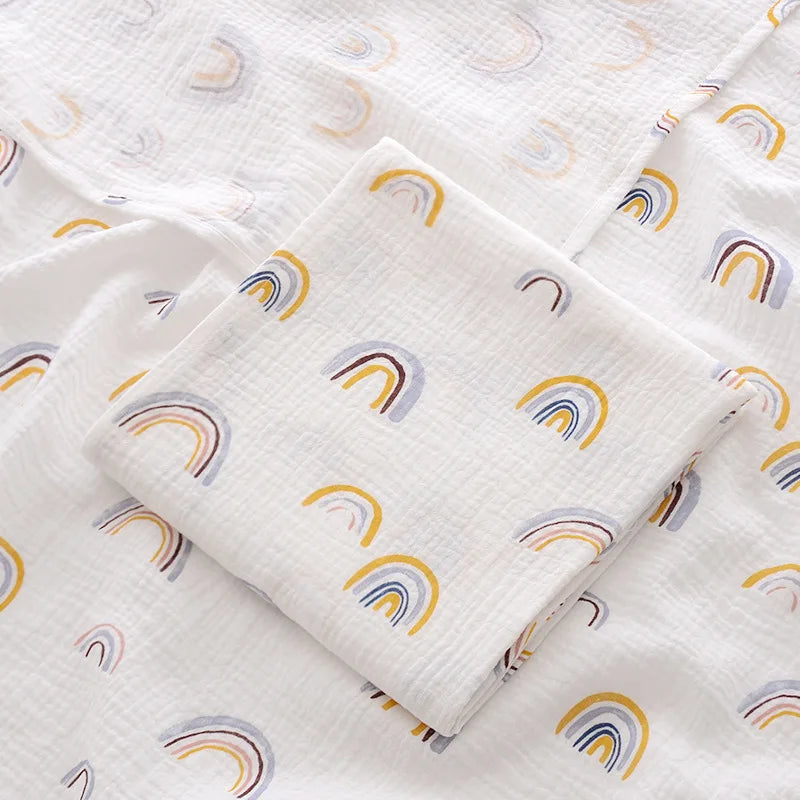 White fabric with rainbow pattern, folded and displayed.