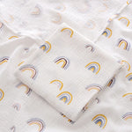 White fabric with rainbow pattern, folded and displayed.