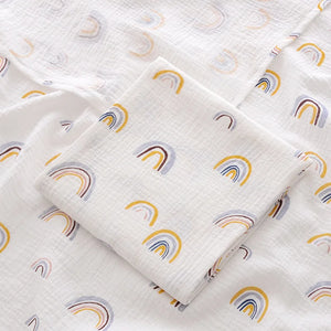 White fabric with rainbow pattern, folded and displayed.