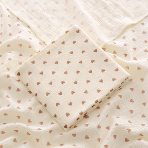 Folded fabric with heart pattern on a textured background