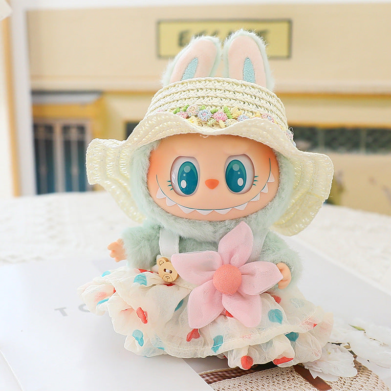 Plush toy with bunny ears and a dress on a light surface