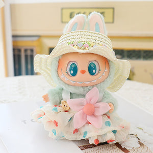 Plush toy with bunny ears and a dress on a light surface