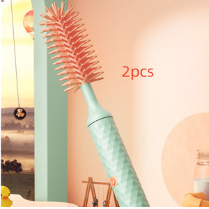 Bottle brush with pink bristles and a light blue handle on a colorful background