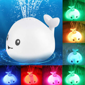 Colorful whale-shaped light with water spray feature on a blue background