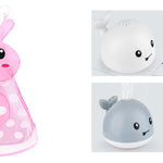 Pink bunny-shaped toy with white polka dots and gray whale-shaped toy on a white background.