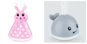 Pink rabbit-shaped toy and gray whale-shaped toy with water sprayer on a white background
