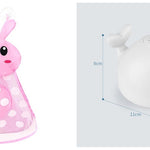Pink bunny-shaped toy with polka dots and a white round toy with smiley face on a light gray background.