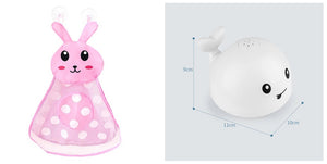Pink bunny-shaped toy with polka dots and a white round toy with smiley face on a light gray background.