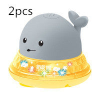 Two cartoon whale-shaped bath toys with a yellow base and gray top on a white background.