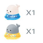 Two whale-shaped bath toys with blue and yellow bases on a white background