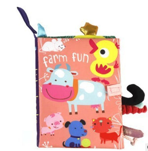 Children's soft book with farm animals on a pink background