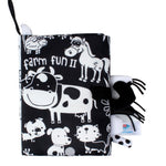 Black and white children's book with farm animal illustrations and a matching soft toy on a white background.
