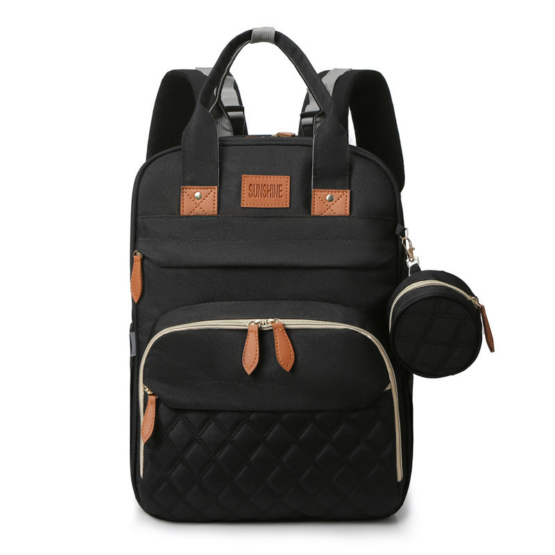 Black backpack with quilted design and brown accents on a white background