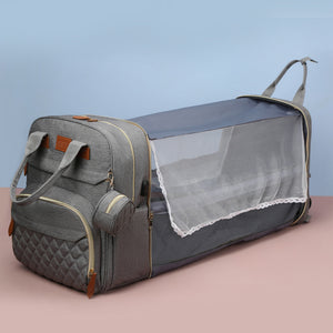 Gray pet carrier with mesh side on a pink surface and light blue background