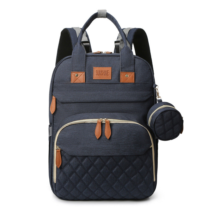 Navy blue backpack with quilted design and brown accents on a white background