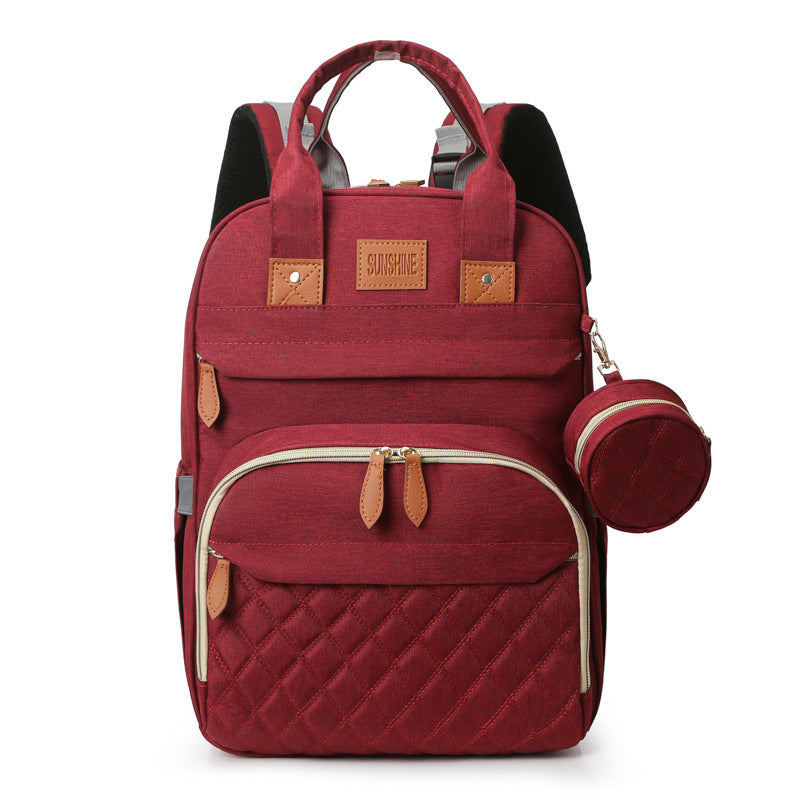 Red backpack with quilted design and matching pouch on a white background