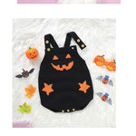 Black Halloween-themed baby romper with orange accents on a white fluffy background