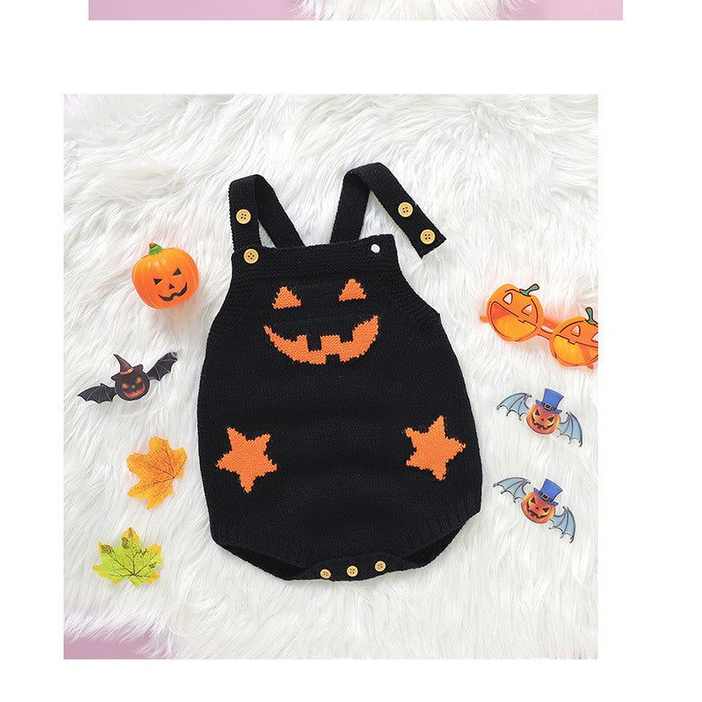 Black Halloween-themed baby romper with orange accents on a white fluffy background