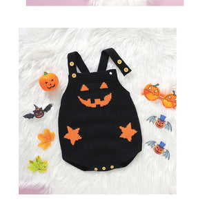 Black Halloween-themed baby romper with orange accents on a white fluffy background
