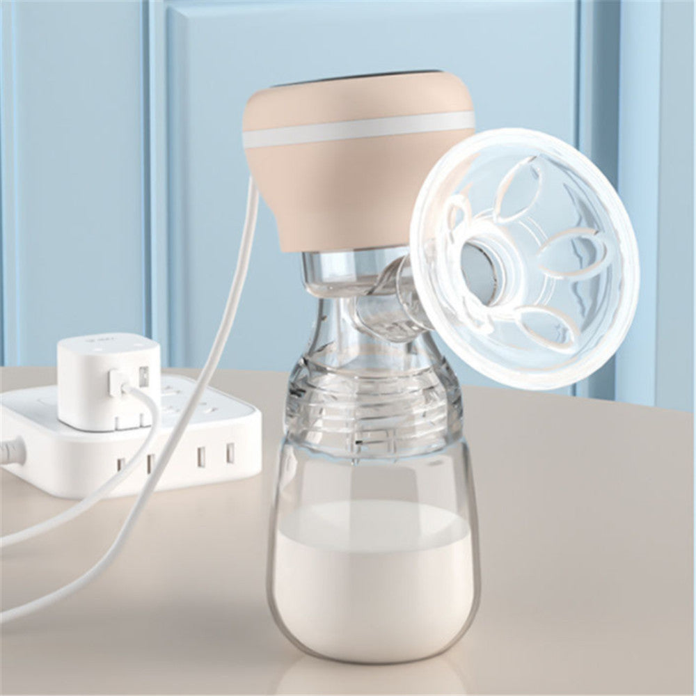 Breast pump with clear bottle and beige top on a light surface with a blue background