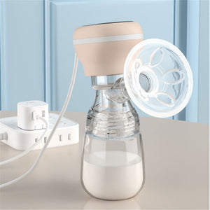 Breast pump with clear bottle and beige top on a light surface with a blue background