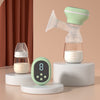 Breast pump and bottles on a beige background