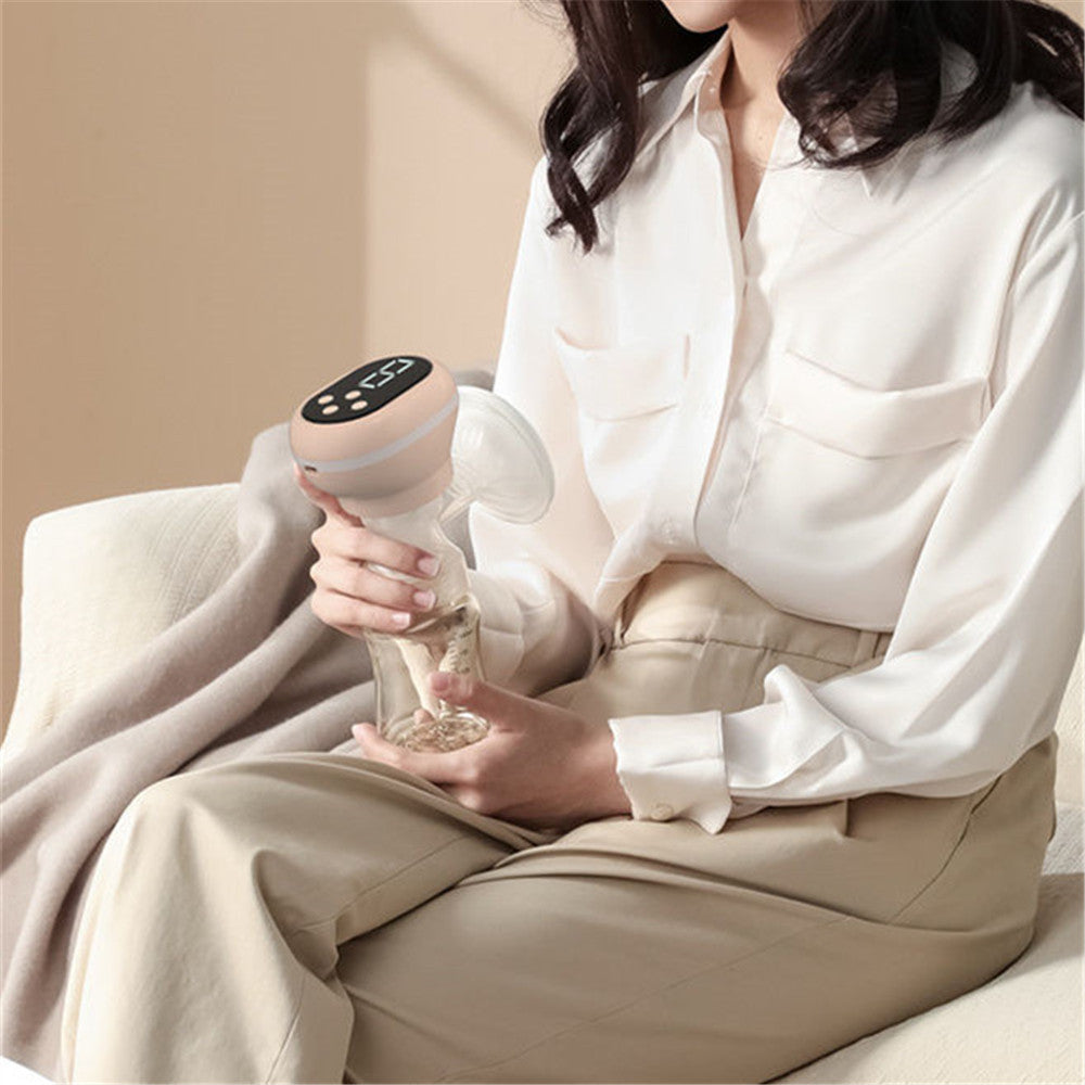 Person holding a handheld device with a beige background