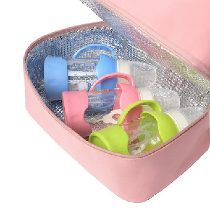 Colorful baby bottle covers in an open pink cooler bag.