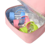Colorful baby bottle covers in an open pink cooler bag.