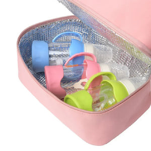 Colorful baby bottle covers in an open pink cooler bag.