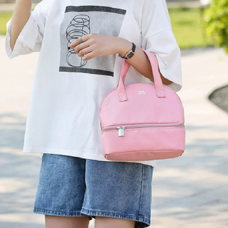 Person holding a pink handbag outdoors