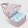 Pink insulated cooler bag with baby bottles inside on a white background