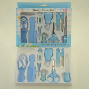 Baby care kit with various tools in packaging on a beige background