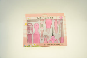 Pink baby care kit with various tools in a box on a light background