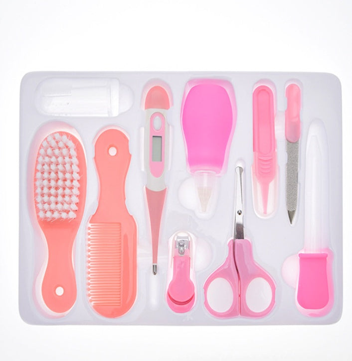 Set of pink baby grooming tools in a clear plastic case on a white background
