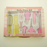 Baby care kit with various tools in a pink box on a light background