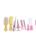 Set of baby care tools including brushes, comb, scissors, and nail care items on a white background