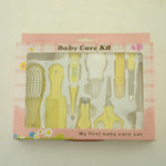 Baby care kit with yellow tools in a pink box on a light beige background