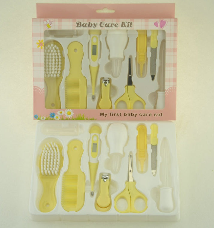 Yellow baby care kit with various tools in packaging on a light background