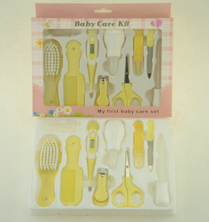 Yellow baby care kit with various tools in packaging on a light background