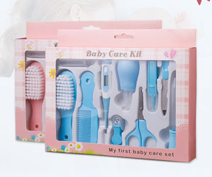 Baby care kit with various tools in a pink box on a white background