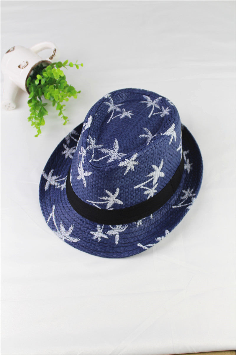 Blue straw hat with white patterns on a white surface