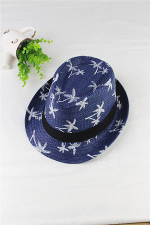 Blue straw hat with white patterns on a white surface