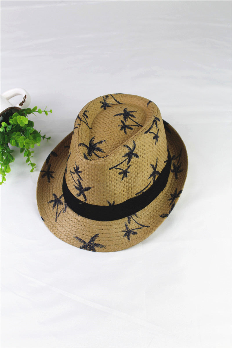 Woven hat with black palm tree pattern and band on a white background
