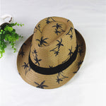 Woven hat with black palm tree pattern and band on a white background