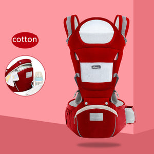 Red baby carrier with cotton label on a pink background