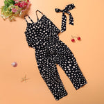 Black and white patterned jumpsuit with a belt on an orange background