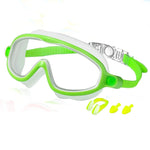 Green and white swim mask with earplugs on a white background