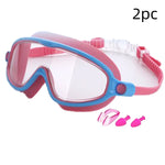 Pink and blue swim goggles with additional components on a white background